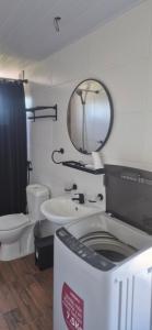 a bathroom with a toilet and a sink and a mirror at Altos de Vella Bista in Bella Vista +18 photos