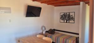 a living room with a couch and a tv on the wall at Altos de Vella Bista in Bella Vista