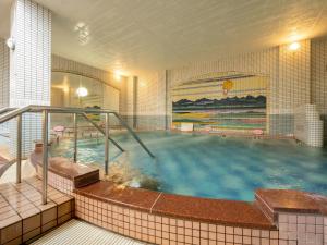 a large pool of water in a building at Hotel Daiheigen in Otofuke +29 photos