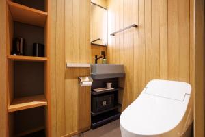a small bathroom with a toilet and a sink at Hotel Ethnography Kiyomizu Gojo in Kyoto +35 photos