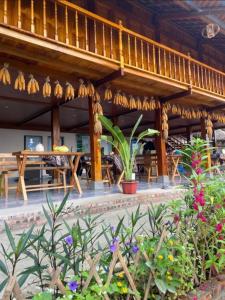 a patio of a restaurant with tables and flowers at Cao bành Homestay in Ha Giang