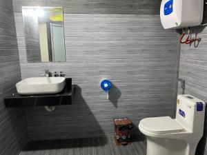 a bathroom with a sink and a toilet at Cao bành Homestay in Ha Giang