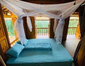 a bed in a room with a canopy at Cao bành Homestay in Ha Giang +8 photos
