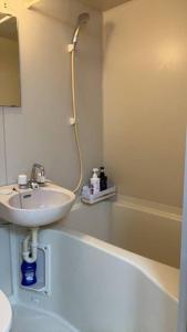 a white bathroom with a sink and a shower at PHEBE3osaka in Osaka +24 photos