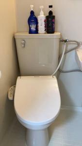 a bathroom with a white toilet with cleaning products on it at PHEBE3osaka in Osaka