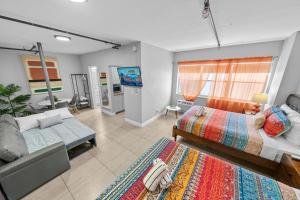 a bedroom with two beds and a flat screen tv at Rock Apartments by Lowkl in Miami Beach