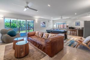 a living room with a couch and a pool table at Softlanding in Mollymook