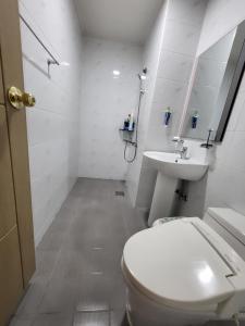 a white bathroom with a toilet and a sink at There Bengdi in Jeju +40 photos