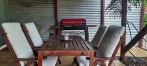 a wooden table and chairs on a patio at Cock or Two Kink House in Cockatoo +19 photos
