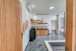 a kitchen with white walls and a counter in a room at Villa Rosie 1BR Brand New Villa In Kerobokan in Kerobokan