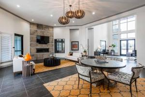 a large living room with a table and chairs at Spacious Furnished Resort Style Apartments in Tomball