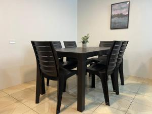 a black dining room table with black chairs at Trendy apartment 2 bedroom 1 bath in Baños +8 photos