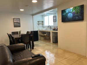 a living room with a couch and a table and a kitchen at Trendy apartment 2 bedroom 1 bath in Baños