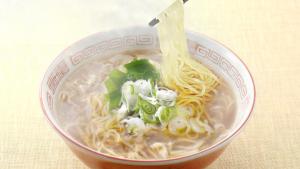a bowl of noodle soup with noodles and green onions at Kanazawa Manten Hotel Ekimae in Kanazawa