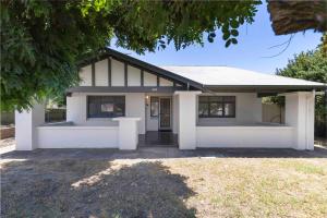 a white house with the front of it at Bobby's Beachside Bungalow in Grange in Grange