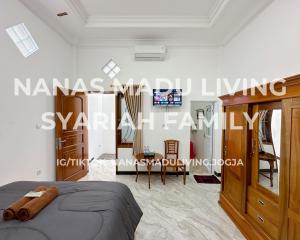 a bedroom with a bed and a dining room at Nanas Madu Living Syariah Family in Adi Sutjipto