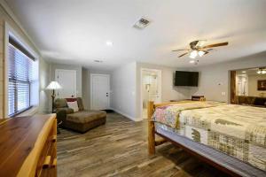 a bedroom with a bed and a ceiling fan at Diamond in the Ruff Hot Tub in Broken Bow
