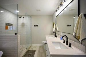 a bathroom with two sinks and a shower at Diamond in the Ruff Hot Tub in Broken Bow +40 photos