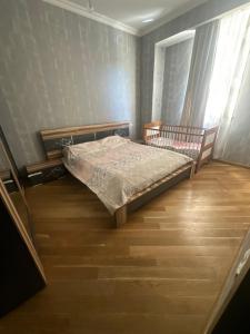 a small bedroom with a bed and a window at Central Park Apartment in Tbilisi City