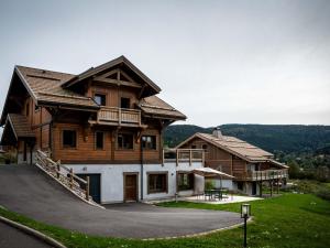 a large wooden house with a patio in front of it at Chalet familial avec sauna et terrasse près du lac - FR-1-589-758 in Xonrupt-Longemer