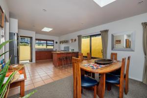 a kitchen and dining room with a table and chairs at Viva Vida View - Paihia Holiday Home in Paihia