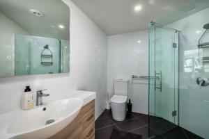 a bathroom with a sink and a glass shower at Viva Vida View - Paihia Holiday Home in Paihia +16 photos
