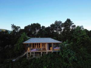 a house with a metal roof on top of trees at Năm mùa Bungalows in Hương Hóa