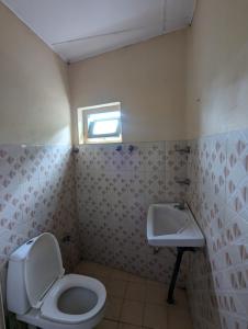 a bathroom with a toilet and a sink at Seven Star Guest Inn in Passara