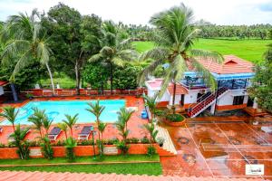 an aerial view of a resort with a swimming pool at Green Fields Kumarakom in Kumarakom