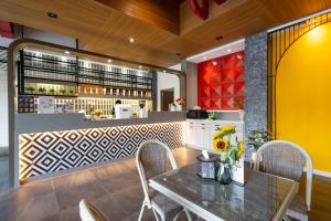 a restaurant with a table and chairs and a counter at Penpark Place in Bangkok