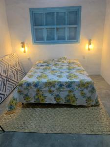 Bett mit Daunendecke in einem Schlafzimmer in der Unterkunft Cajumar in Cajueiro