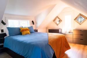 a bedroom with a blue bed in a attic at Unique Denver Tiny House Skiing, Shopping, Hiking in Englewood