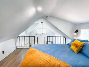 a bedroom with a blue bed with yellow pillows at Unique Denver Tiny House Skiing, Shopping, Hiking in Englewood +10 photos