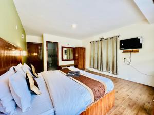 Una televisión o centro de entretenimiento en Hotel The Sliver land # Mountain view # River view # Near Volvo Bus Stand # Family Hotel # Open Terrace