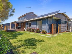 a house with a lawn in front of it at Tempting Tamara in Inverloch