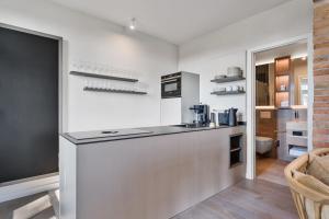 a kitchen with a counter with a coffee maker at Alte Schule Westerhever Tholendorf in Westerhever +20 photos