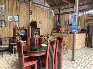 a restaurant with a table and chairs and a bar at Just Inn in El Nido