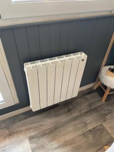 a radiator in a room with a blue wall at Appartement de montagne in Prémanon