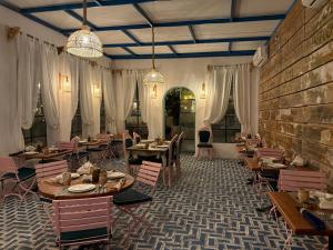 a restaurant with tables and chairs and a brick wall at Banan Beach in Ras al Khaimah