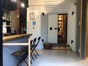 a kitchen with chairs and a counter in a room at Aomori Kurahaku 青森蔵泊 in Kuroishi +15 photos