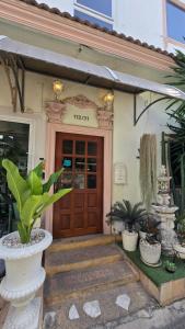 a front door of a house with a plant at Wang Lang Hostel in Bangkok