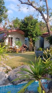 a person sitting in the yard of a house at Tran Chau Garden Home in Cat Ba