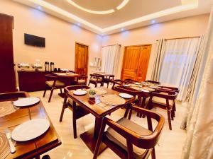 a large dining room with wooden tables and chairs at Clisa Rest House in Karatu