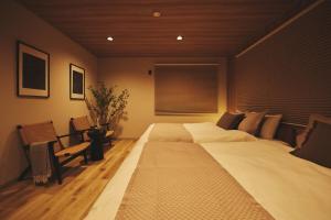 a large bed in a room with a window at New open 都心の一軒家貸切 232平米 新宿駅4分 渋谷10分 無料駐車場3台 最寄駅2分 in Tokyo