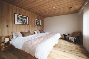 ein Schlafzimmer mit einem großen Bett und einer Holzdecke in der Unterkunft New open 都心の一軒家貸切 232平米 新宿駅4分 渋谷10分 無料駐車場3台 最寄駅2分 in Tokio