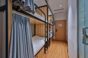 Postel nebo postele na pokoji v ubytování Shanghai Pengpai Art Youth Hotel