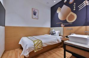 Postel nebo postele na pokoji v ubytování Shanghai Pengpai Art Youth Hotel