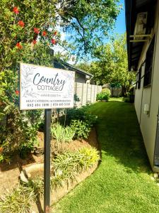 a sign for a community garden in a yard at Harrismith Country Cottage in Harrismith +11 photos