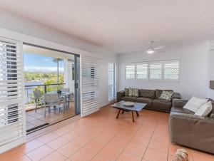 a living room with a couch and a table at Sunrise Cove 12 in Kingscliff