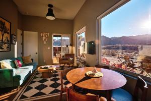 a living room with a couch and a table at Sacred Sands - Lobo Luna in Joshua Tree
